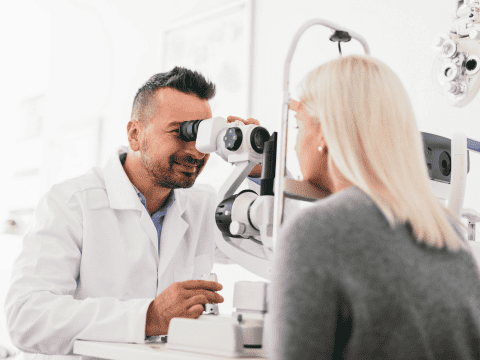 A woman receives an eye test from an optometrist