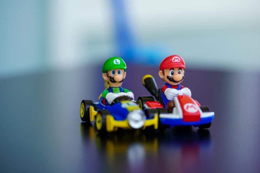 Mario-Kart - Softwire Two Super Mario Kart toys showing Mario and Luigi in their karts.